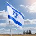 The flag of Israel on a field and a cloudy sky background. Memorial day-Yom Hazikaron, Patriotic holiday Independence day Israel - Yom Ha'atzmaut concept.